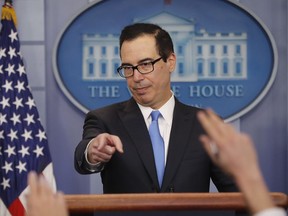 FILE - In this Feb. 23, 2018, file photo, Treasury Secretary Steve Mnuchin gestures as he answers questions during a briefing at the White House in Washington. It looks like President Donald Trump's romance with the Goldman Sachs crowd is going cold. Top economic adviser Gary Cohn is only the latest Goldman figure to head for the White House exits. Cohn is the fourth high-profile Goldman alumni to leave the administration. That makes Mnuchin the last Goldman veteran in a top administration job.
