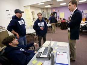 In this March 7, 2018, photo, Democrat Conor Lamb, right, talks with some of his campaign workers at a campaign office in Carnegie, Pa. Lamb is running against Republican Rick Saccone in a special election being held on March 13 for the PA 18th Congressional District vacated by Republican Tim Murphy.