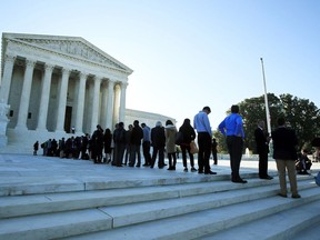 FILE - In this Oct. 3, 2017, file photo, people line up outside the U.S. Supreme Court in Washington to hear arguments in a case about political maps in Wisconsin that could affect elections across the country.  The Supreme Court has already heard a major case about political line-drawing that has the potential to reshape American politics. Now, before even deciding that one, the court is taking up another similar case. Decisions in the Maryland case and the earlier one from Wisconsin are expected by late June.