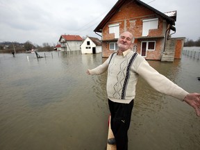 Bosnian Milan Ilic gestures whilst showing the level of flooded water from the Sava River in front of his house in the village of Bistrica near Gradiska, 260 kms northwest of the Bosnian capital of Sarajevo, Thursday, March 22, 2018. Heavy rain and melting snow caused flooding along the River Sava and the border with Croatia forcing many people to leave their homes.