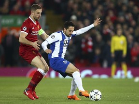 Liverpool's Jordan Henderson, left, vies for the ball with Porto's Bruno Costa during the Champions League round of 16, second leg, soccer match between Liverpool and FC Porto at Anfield Stadium, Liverpool, England, Tuesday March 6, 2018.