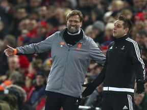 Liverpool coach Jurgen Klopp talks with the fourth official, right, during the Champions League round of 16, second leg, soccer match between Liverpool and FC Porto at Anfield Stadium, Liverpool, England, Tuesday March 6, 2018.