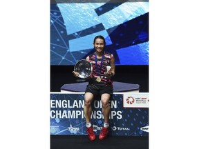 Taiwan's Tai Tzu Ying poses with her trophy after defeating Japan's Akane Yamaguchi in the women's singles final match at the All England Open Badminton tournament in Birmingham, England, Sunday March 18, 2018.