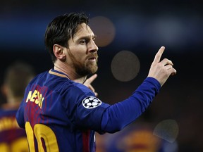 Barcelona's Lionel Messi celebrates after scoring the opening goal during the Champions League round of sixteen second leg soccer match between FC Barcelona and Chelsea at the Camp Nou stadium in Barcelona, Spain, Wednesday, March 14, 2018.