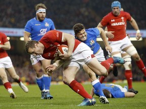 Wales' Hadleigh Parkes goes over the line to score a try during the Six Nations rugby union match between Wales and Italy at the Principality Stadium in Cardiff, Wales, Sunday, March 11, 2018.