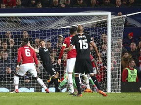 Sevilla's Wissam Ben Yedder, at right reacts after he scores his sides second goal of the game during the Champions League round of 16 second leg soccer match between Manchester United and Sevilla, at Old Trafford in Manchester, England, Tuesday, March 13, 2018.