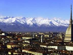 FILE -- A view of Turin, Italy, with the main city landmark, the Mole Antonelliana, at right, and the Alps in background are seen in this December 2005 photo. Milan and Turin are in discussions with the Italian Olympic Committee over a possible bid for the 2026 Winter Games. Turin Mayor Chiara Appendino sent a letter of interest to CONI on Sunday despite divisions in her own party, the populist 5-Star Movement, on a candidacy.