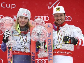 Austria's Marcel Hirscher and United States's Mikaela Shiffrin hold their World Cup trophies, at the alpine ski World Cup finals in Are, Sweden, Sunday, March 18, 2018.