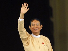 Win Myint, newly elected president of Myanmar, waves to media outside the parliament in Naypyitaw, Myanmar, in Naypyitaw, Myanmar, Wednesday, March 28, 2018. Myanmar's parliament has elected Win Myint, a loyalist of Aung San Suu Kyi, as new president. Suu Kyi, who formal title is state counsellor, has retained her executive authority over the government.