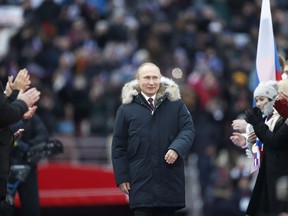 Russian President Vladimir Putin arrives to attend a massive rally in his support as a presidential candidate at the Luzhniki stadium in Moscow, Russia, Saturday, March 3, 2018.