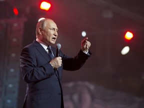 Russian President Vladimir Putin gestures while speaking at a youth forum "Russia, Land of Opportunity" in Moscow, Russia, Thursday, March 15, 2018.