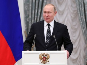 Russian President Vladimir Putin addresses Russian Paralympics Athletes who competed in the 2018 Pyeonchang Winter Paralympics, in the Kremlin in Moscow, Russia, Tuesday, March 20, 2018.