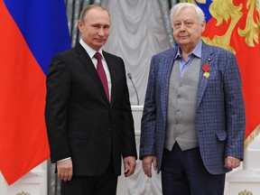 FILE In this file photo taken on Thursday, Dec. 10, 2015, Russian President Vladimir Putin, left, gives a medal to artistic director of the Chekhov Moscow Art Theater Oleg Tabakov during an award ceremony in the Kremlin in Moscow, Russia. Oleg Tabakov, a Russian actor and theater director who has been one of the most revered figures in the Russian theater community and film industries for decades, has died. He was 82.