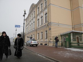 People walk passed the British Consulate General in St.Petersburg, Russia, Saturday, March 17, 2018.  Russia on Saturday announced it is expelling 23 British diplomats and threatened further measures in retaliation in a growing diplomatic dispute over a nerve agent attack on a former spy in Britain.