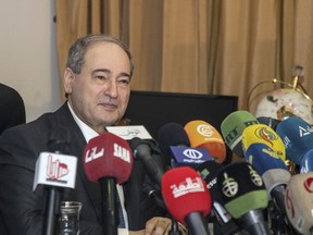 This photo released by the Syrian official news agency SANA, Syrian Deputy Foreign Minister Faisal Mekdad, speaks during a news conference in Damascus, Syria, Saturday, March  10, 2018. Mekdad denied opposition charges that government forces used poison gas in their attacks on eastern Ghouta. Mekdad added that insurgents groups in the eastern Ghouta are preparing "to fabricate" more such attacks to blame the Syrian army.