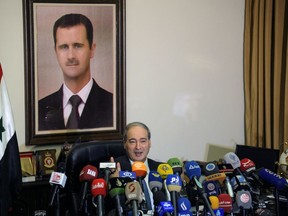 This photo released by the Syrian official news agency SANA, Syrian Deputy Foreign Minister Faisal Mekdad, speaks during a news conference in Damascus, Syria, Saturday, March 10, 2018. Mekdad denied opposition charges that government forces used poison gas in their attacks on eastern Ghouta. Mekdad added that insurgents groups in the eastern Ghouta are preparing "to fabricate" more such attacks to blame the Syrian army.