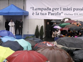 Pope Francis delivers his message as he meets members of the Sant'Egidio community, on the occasion of the 50th anniversary of its foundation, in Santa Maria in Trastevere basilica, in Rome, Sunday, March 11, 2018. Banner hanging at right reads from Psalm 119:105 "Your word is a lamp for my feet, a light for my path."