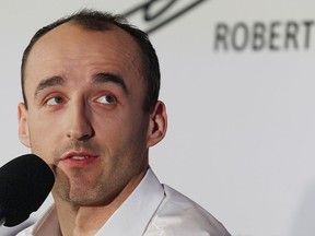 F1 reserve driver for Williams, Robert Kubica who almost lost his right hand in a 2011 rally crash, talks to reporters about his motivation for the comeback and his dream of returning to racing, in Warsaw, Poland, Thursday, March 29, 2018.