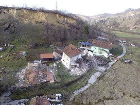 This aerial photo shows buildings damaged by a landslide caused by melting snow in Kostajnica, central Croatia, Tuesday, March 13, 2018.  The incident happened just as Prime Minister Andrej Plenkovic attended an emergency session of the local authorities battling floods in the area. Reports say no one appears to have been seriously injured. (AP Photo)