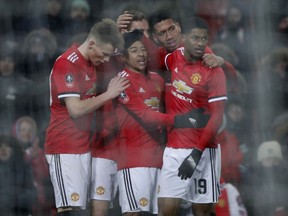 Manchester United players celebrate their second goal during the English FA Cup quarterfinal soccer match between Manchester United and Brighton, at the Old Trafford stadium in Manchester, England, Saturday, March 17, 2018.