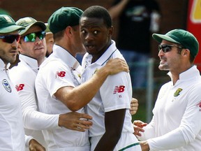 FILE -- In this March 9, 2018 file photo South Africa's bowler Kagiso Rabada, second right, celebrates a wicket with team mates during the second cricket test match between South Africa and Australia at St George's Park in Port Elizabeth, South Africa. Rabada has had his two-test ban overturned on appeal and will be available for the remainder of the series against Australia.