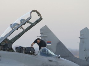 In this photo taken Tuesday, Oct. 17, 2017, Serbian Defense Minister Aleksandar Vulin inspects a Mig 29 fighter jet at the military airport Batajnica, near Belgrade, Serbia. Vulin said Monday March 12, 2018, that U.S. Army Gen. Curtis Scaparrotti's statement, made last week during a U.S. Senate Armed Services Committee hearing, is the most "dangerous" anti-Serb statement since the Western military alliance bombed the country in 1999.