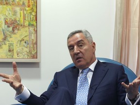 In this Tuesday, March 14, 2017 file photo, Montenegro's former Prime Minister Milo Djukanovic speaks during an interview with The Associated Press, in Podgorica, Montenegro. Montenegro's ruling party says its leader Milo Djukanovic, who took the Balkan country to independence and into NATO in defiance of Russia, will run for the presidency in next month's election.