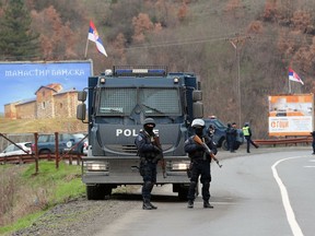 Kosovo police block a road near the northern, Serb-dominated part of Mitrovica, Kosovo, Monday, March 26, 2018. Serbian state television says Kosovo police have arrested one Serb official and fired tear gas and stun grenades at Serb protesters in northern Kosovo.