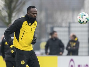 Jamaica's former sprinter Usain Bolt takes part in a practice session of the Borussia Dortmund soccer squad in Dortmund, Germany, Friday, March 23, 2018.