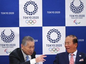 Tokyo 2020 Olympics President Yoshiro Mori, left, and Tokyo Organizing Committee CEO of the 2020 Olympics Toshiro Muto, right, chat prior to the beginning of the Executive Board Meeting opening of Tokyo Organizing Committee of the Olympics an Paralympic Games (Tokyo 2020) in Tokyo Wednesday, March 28, 2018.