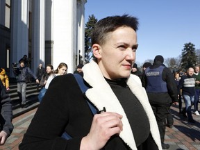 Lawmaker Nadiya Savchenko leaves the parliament building after a vote on her detention in Kiev, Ukraine, Thursday, March 22, 2018. The Ukrainian parliament on Thursday cancelled Savchenko's lawmaker immunity and approved her detention after the country's top prosecutor accused Savhcheno of an attempt to prepare terrorist attacks against the country's leaders.