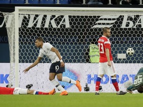 France's Kylian Mbappe, centre, celebrates scoring the opening goal during the international friendly soccer match between Russia and France at the Saint Petersburg stadium in St.Petersburg, Russia, Tuesday, March 27, 2018.
