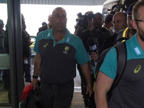 Australian cricket coach Darren Lehmann arrives with his team at the Cape Town International airport as they  depart to Johannesburg for the final five day cricket test match, in Cape Town, South Africa, Tuesday, March 27, 2018. Australia skipper Steve Smith has been suspended by the International Cricket Council for the match for his part in a ball tampering scandal during the third test. Smith admitted some senior players were aware of the tampering attempt.