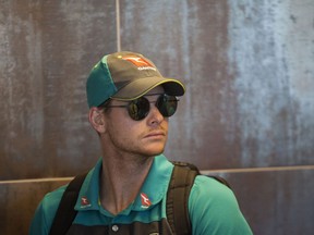 Australian cricket captain Steve Smith arrives with teammates, at the Cape Town International airport to depart to Johannesburg for the final five day cricket test match, in Cape Town, South Africa, Tuesday, March 27, 2018. Smith has been suspended by the International Cricket Council for the match for his part in a ball tampering scandal during the third test. Smith admitted some senior players were aware of the tampering attempt.