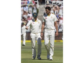 Steven Smith of Australia and Mitchell Starc of Australia discuss strategy on the first day of the third cricket test match between South Africa and Australia at Newlands Stadium, in Cape Town, South Africa, Thursday, March 22, 2018.