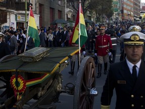 Bolivian military escort the remains of the Bolivian national hero Eduardo Abaroa, to be exhibited on the "Day of the Sea," in La Paz, Bolivia, Thursday, March 22, 2018. Abaroa died fighting off a Chilean attack during the 1879 to 1883 war in which Bolivia lost its only access to the sea. Bolivia celebrates its "Day of the Sea" on Friday, March 23.