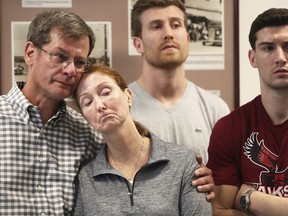 Parents John and Lisa Dombroski, left, stand with their sons John, behind, and Kevin during a press conference regarding their missing son and brother Mark, at the Hamilton Police Station in Hamilton, Bermuda, Monday, March 19, 2018. Mark Dombroski, 19, a member of the rugby team at Saint Joseph's University in Philadelphia, disappeared early Sunday after a night of socializing at the end of an international rugby tournament.