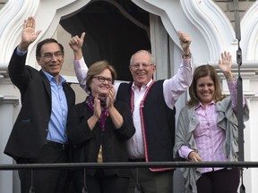 FILE - This June 6, 2016 file shows then presidential candidate Pedro Pablo Kuczynski and his wife Nancy Lange, flanked by his running mates Martin Vizcarra, left, and Mercedes Araoz, right, greeting supporters and reporters outside Kuczynski's home in Lima, Peru. Pressure built on Peru's President Pedro Pablo Kuczynski to resign Wednesday, March 21, 2018, after several allies were caught in secretly-shot videos allegedly trying to buy the support of a lawmaker to block the conservative leader's impeachment.