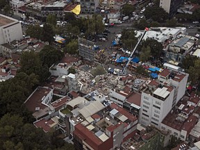 FILE - This Sept. 23, 2017 file photo shows the site of the earthquake-collapsed office building on Alvaro Obregon Avenue in the Roma Norte neighborhood of Mexico City. The city government is taking ownership of the lot where the seven-story office building collapsed in September's deadly earthquake, clearing the way for a planned park memorializing victims of the disaster. Forty-nine people died in the building when it collapsed Sept. 19.