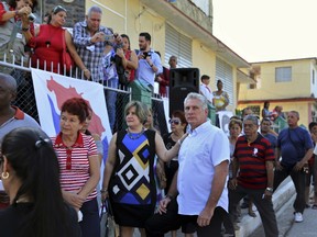 Cuba's Vice President Miguel Diaz-Canel, center right, and his wife Lis Cuesta Peraza wait in line at a voting center during elections for national and provincial representatives for the National Assembly in Santa Clara, Cuba, Sunday, March 11, 2018.