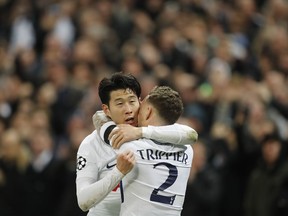 Tottenham's Son Heung-min, left, celebrates after scoring the opening goal with his teammate Kieran Trippier, during the Champions League, round of 16, second-leg soccer match between Juventus and Tottenham Hotspur, at the Wembley Stadium in London, Wednesday, March 7, 2018.