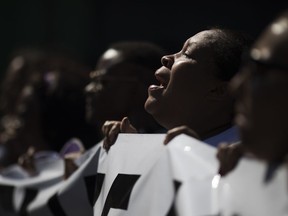 People shout "Marielle present!" during a march against the murder of councilwoman and human rights activist Marielle Franco, and her driver Anderson Pedro Gomes, in the Mare Complex slum of Rio de Janeiro, Brazil, Sunday, March 18, 2018. Franco's murder came just a month after the government put the military in charge of security in Rio, which is experiencing a sharp spike in violence less than two years after hosting the 2016 Summer Olympics.