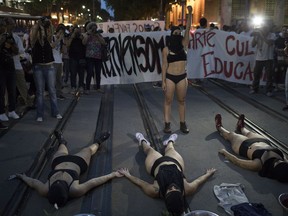 Demonstrators perform during a protest against the murder of councilwoman Marielle Franco in Rio de Janeiro, Brazil, Tuesday, March 20, 2018. Franco's murder came just a month after the government put the military in charge of security in Rio, which is experiencing a sharp spike in violence less than two years after hosting the 2016 Summer Olympics.