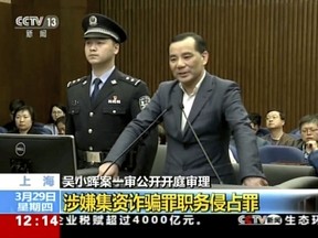 In this image taken from undated video footage run by China's CCTV via AP Video, Wu Xiaohui, the former chairman of the Anbang Insurance Group, speaks during a court session at the Shanghai No. 1 Intermediate People's Court in Shanghai. The founder of the Chinese insurer that owns New York City's Waldorf Hotel went on trial Wednesday, March 28, 2018 on charges he fraudulently raised $10 billion from investors and misused his position to enrich himself.