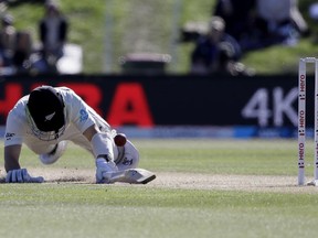New Zealand's BJ Watling dives to make his ground while batting during play on day three of the second cricket test against England at Hagley Oval in Christchurch, New Zealand, Sunday, April 1, 2018.