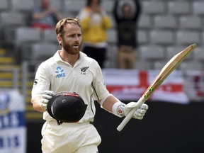New Zealand's Kane Williamson signals his century against England during their first cricket test in Auckland, New Zealand, Friday, March 23, 2018.