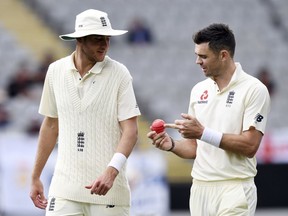 England's Stuart Broad, left and James Anderson discuss the pink ball against New Zealand during the first cricket cricket test in Auckland, New Zealand, Friday, March 23, 2018.