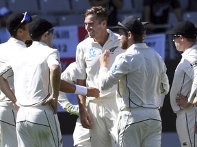 New Zealand's Tim Southee, centrer, celebrates after dismissing England's Chris Broad for 0 during their first cricket test in Auckland, New Zealand, Thursday, March 22, 2018.