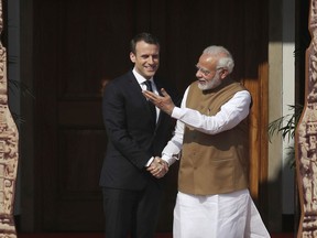 Indian Prime Minister Narendra Modi, right, welcomes French President Emmanuel Macron at the International Solar Alliance founding conference in New Delhi, India, Sunday March 11, 2018. Modi and Macron on Sunday co-chaired the first Founding Conference of International Solar Alliance (ISA) in the capital. The summit which was representative by more than fifty countries aims to mobilize $1 trillion of investments by 2030 for massive deployment of solar energy.