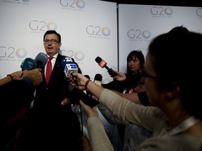 The press surrounds Spanish Economy, Industry and Competitiveness Minister, Roman Escolano, as he speaks on the sidelines of the G20 finance ministers and central bankers summit in Buenos Aires, Argentina, Tuesday, March 20, 2018. Finance ministers and central bankers of G20 countries are meeting in Argentina at a summit eclipsed by growing concerns over U.S. President Donald Trump's import tariffs on steel and aluminum and the potential of a trade war.